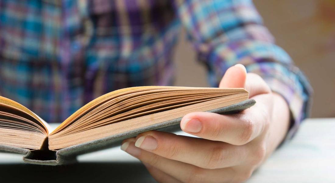 Closeup hand open book for reading concept background